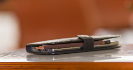 Cellphone and pencil in leather case
