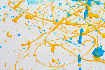 Colorful paint splashes on white canvas as background. Art and creativity