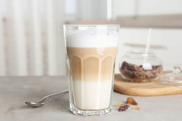 Delicious latte macchiato in glass on grey table indoors