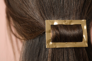 Woman with beautiful gold hair clip, closeup