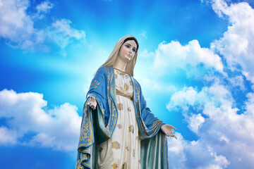 Our lady of grace virgin Mary with Bright Blue Sky and beautiful clouds with abstract colored background and wallpaper