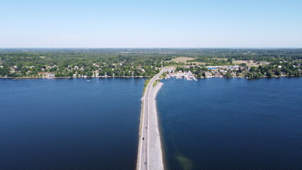 Image of Highway road spanning through lake during clear summer weather