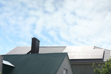 Fototapeta na wymiar Modern house roof with solar panels outdoors