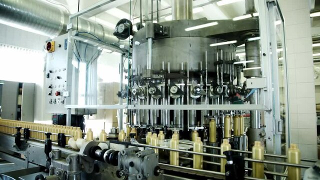 Cosmetic bottles on automated conveyor. Automated conveyor cosmetic factory