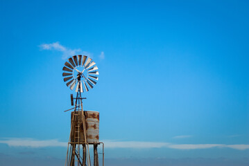 Windmill in empty farm field in outback Australia.