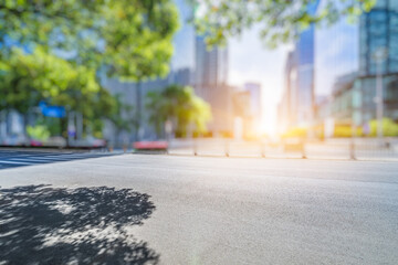 empty asphalt road near glass office building.