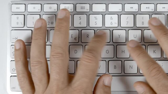 Overhead video of person typing on computer keyboard