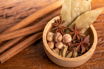 Spices and herbs ingredients for cooking Curry, Curry powder, clove, cardamom, cinnamon, caraway on wooden background.