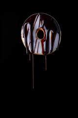 glazed doughnut with melted chocolate on dark background