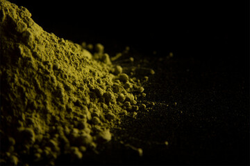 Closeup of powdered matcha green tea on black table