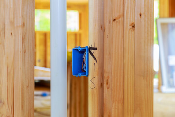 Work on installing electrical outlets mounts in new home
