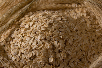 Rolled oats on wheat grains back ground