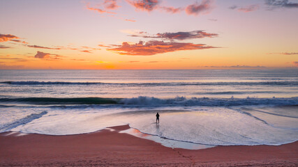 Person standing on beach aerial sunrise ocean view on Gold Coast