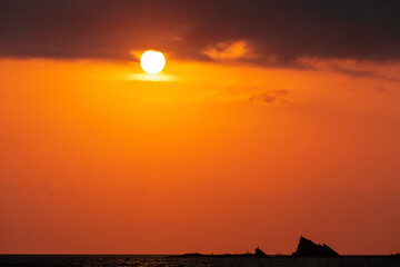 Sun rising into high clouds over Currumbin Rock Gold Coast