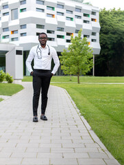 Smart Looking Doctor Standing On Wearing White Shirt And Black Trousers Walking