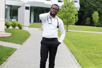 Exhausted Medical Doctor Feeling Pain and Holding Neck Standing On Pavement With Eyes Closed