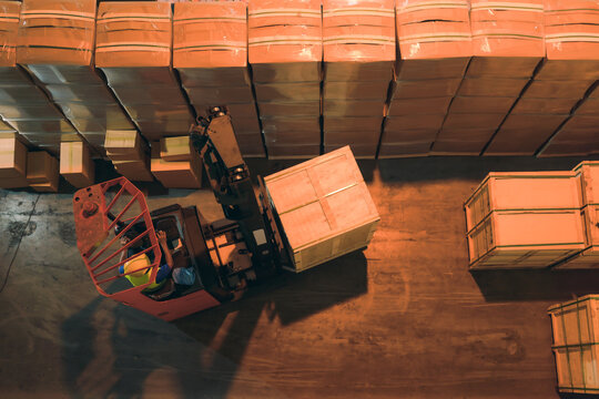 forklift in operation of moving pallet in storage warehouse