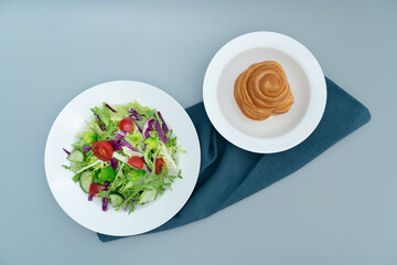 A plate of healthy and delicious salad and a bread