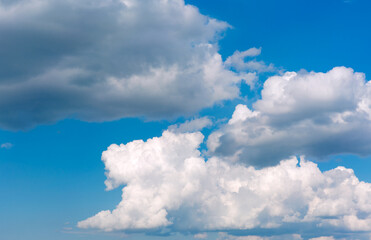 White clouds on blue sky background.