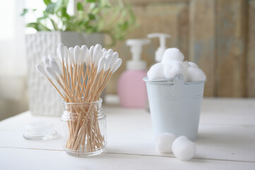 White cotton swabs cotton bud and cotton ball on background