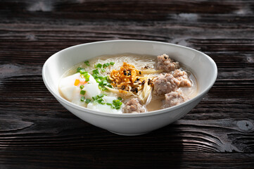 Thai style clear soup rice noodle in traditional bowl. Selective focus