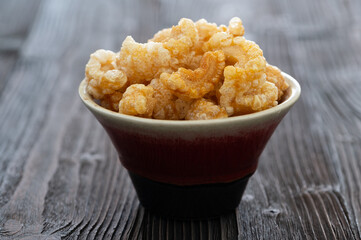 Homemade deep fried crispy pork rind in bowl.