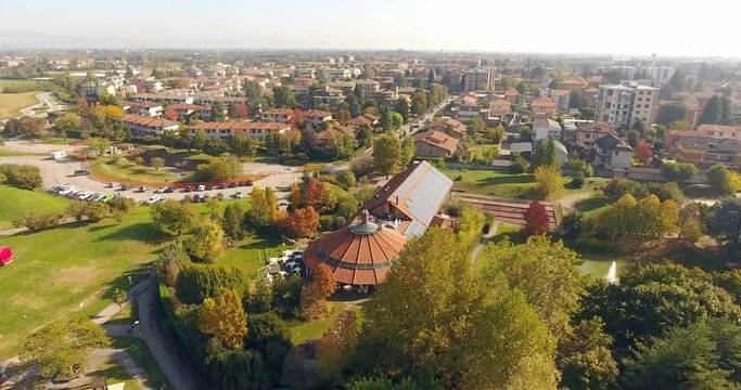 Aerial over a building with solar panels in a city park