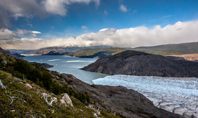 Glacier ending at a lake in the mountains