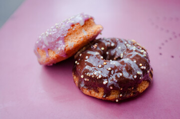 baked vegan gluten free chocolate and strawberry donuts doughnuts on a pink antique table