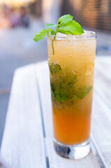 ice cold long island tea cocktail with mint in outdoor backyard
