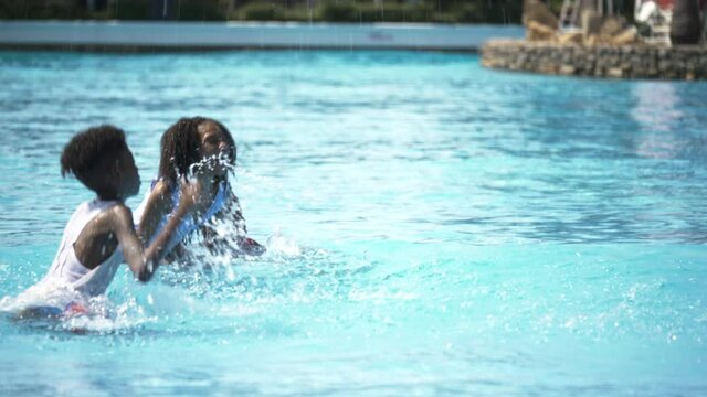 Group African American children play in the pool happy with a smile the vacation. Family Boy and girl Summer water play activities during holiday the long weekend. Concept of living together
