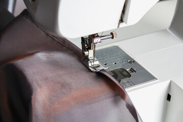 A man hem a curtain on a sewing machine. Sewing, hobbies, hobby, home improvement.