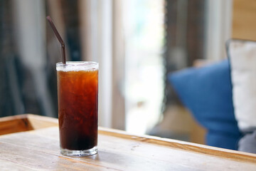 Iced americano - A glass of black coffee on table and copy space, The style of coffee prepared by brewing espresso and mixed with water, Perfect for breakfast time, Refreshing summer drink concept.