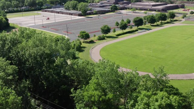 Aerial tilting up shot of a Midwestern elementary school. 4K