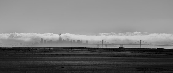 San Francisco, Ca. skyline and Bay Bridge on a foggy day seen from Alameda  