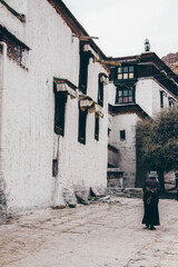 Fototapeta premium A Tibet elder woman walking in a temple.