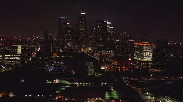 AERIAL: Flying into Downtown Skyscrapers,Skyline Los Angeles, California at Night with City Lights, 