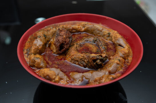 A bowl of amala with ewedu and gbegiri sauce with stewed fried mackarel and eja kika