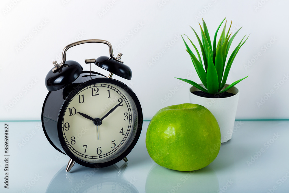 Wall mural Alarm Clock, aloe vera, apple on a white background. The concept of a healthy lifestyle, sport, diet.  The concept of time is precious.