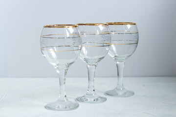 Crystal glasses with gold patterns. Selective focus