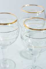 Crystal glasses with gold patterns. Selective focus