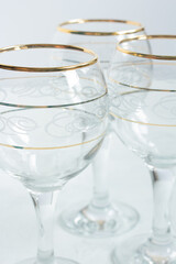 Crystal glasses with gold patterns. Selective focus