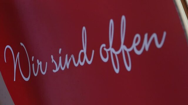 "Wir sind offen" sign, We are open, white font on red background