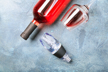 Bottle of wine, glass and aerator on color background