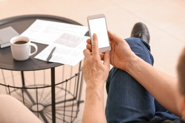 Man with mobile phone at home