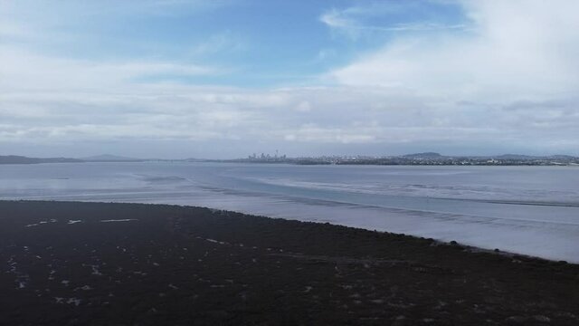 drone_flying towards sea and auckland city view