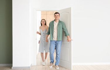 Happy couple opening door at their new home