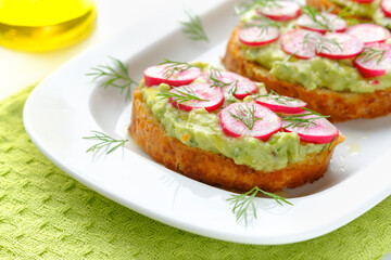 Delicious vegan sandwiches with radish and avocado. Horizontal orientation.