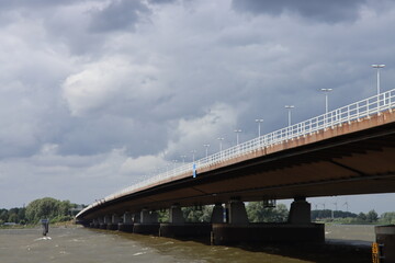 Dark clouds above the Moerdijkbrug over water named Hollands Diep.