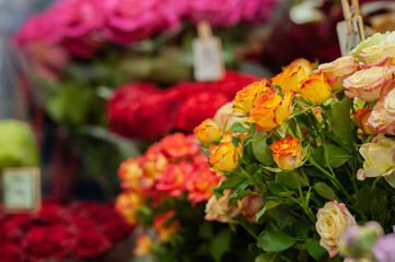 Obraz na płótnie Canvas Yellow and red roses in the window of a flower shop. Flowers in the refrigerator. Small business. Selective focus.